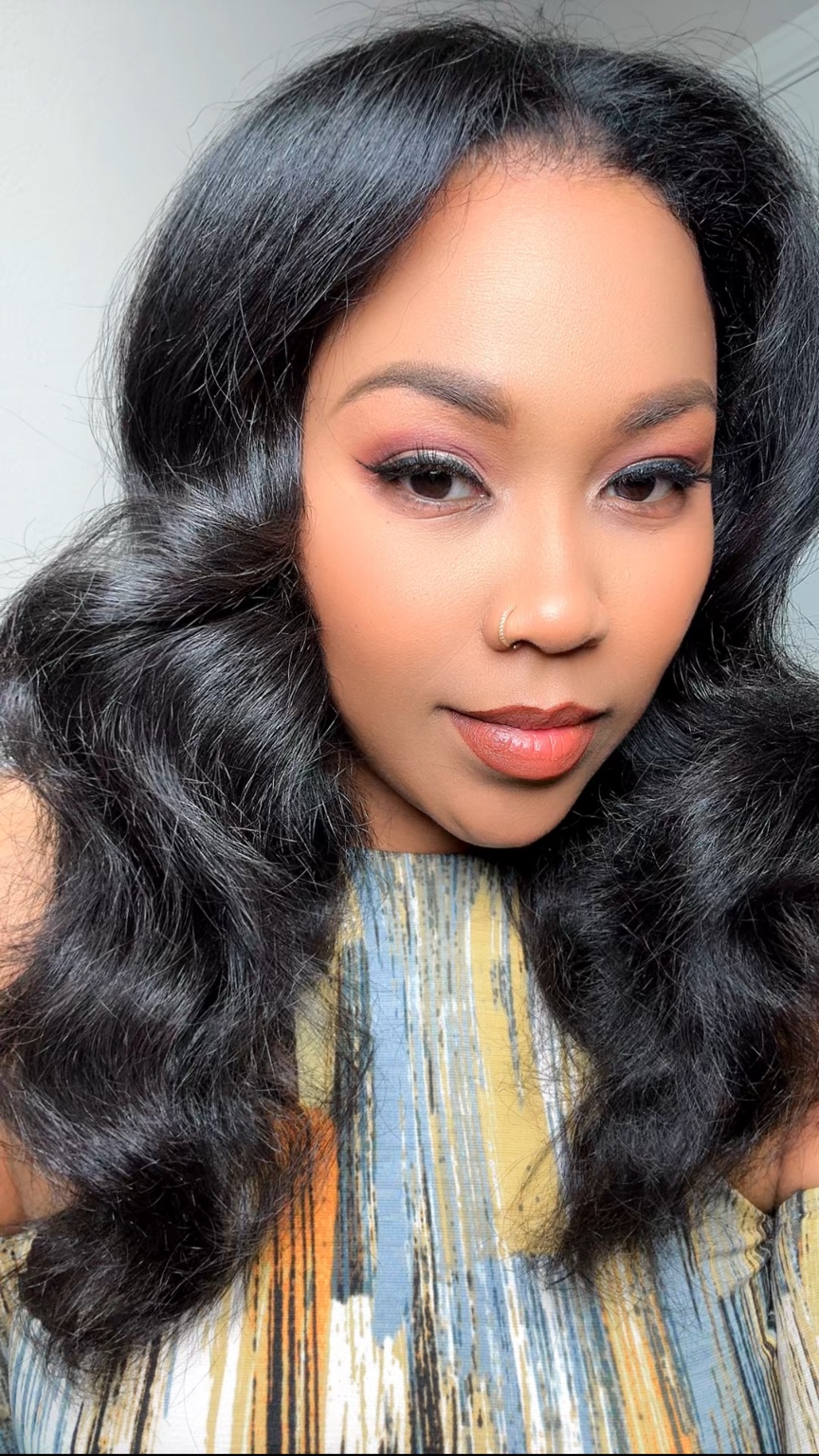 Long black hair styled in soft waves around 2021